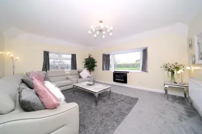 a living room with a couch and a table at Lower Lodge in Cardeston