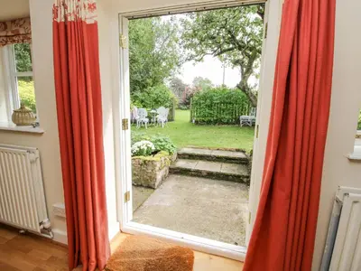 an open door with a view of a yard at The Coach House in Ludlow