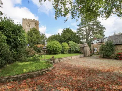 an estate with a church and a driveway at The Coach House in Ludlow
