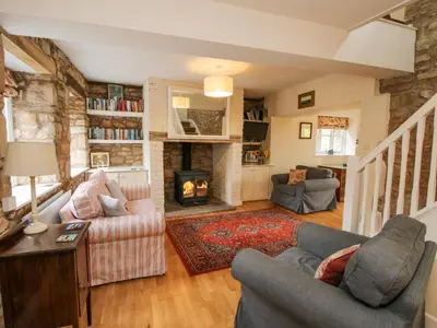 a living room with two couches and a fireplace at The Coach House in Ludlow