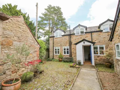 an exterior view of a brick house at The Coach House in Ludlow