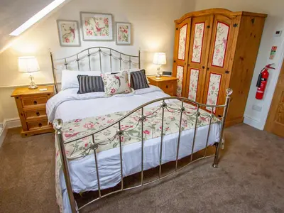 a bedroom with a bed and two night stands at The Old Chapel in Shelve
