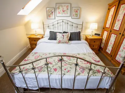 a bedroom with a metal bed and two night stands at The Old Chapel in Shelve
