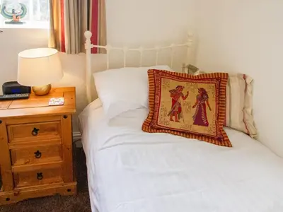 a bedroom with a bed with a pillow on it at The Old Chapel in Shelve