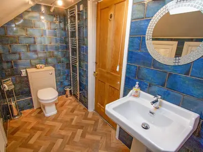 a bathroom with a sink and a toilet and a mirror at The Old Chapel in Shelve