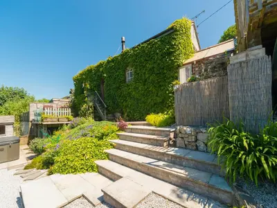 a garden with stairs leading up to a house at The Old Chapel in Shelve