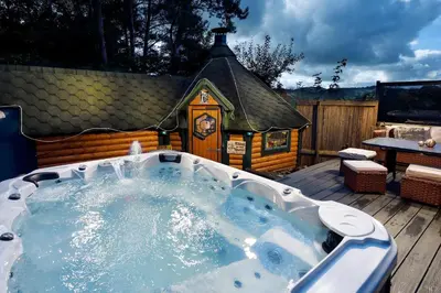 a jacuzzi tub in front of a small house at The Coach House in Oswestry