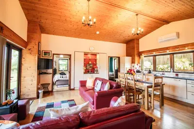 a living room with a couch and a table at Sycamore Lodge in Rhayader