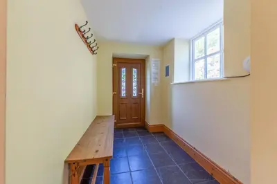 a hallway with a wooden bench and a door at Maesgwyn in Felindre