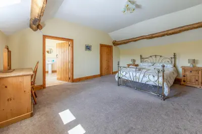 a bedroom with a bed and a dresser in a room at Maesgwyn in Felindre