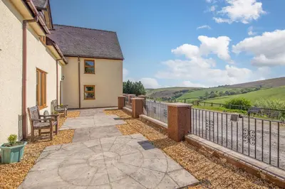 a patio of a house with a fence at Maesgwyn in Felindre