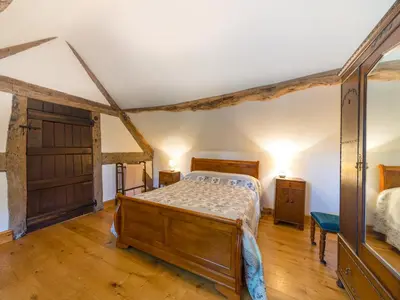 a bedroom with a bed and a wooden floor at Stone House in Ludlow