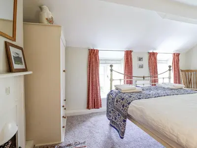 a bedroom with a bed and a window at Haulfryn in Llangynog