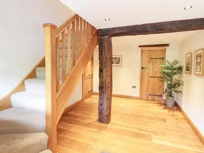 a staircase in a house with wooden beams at Ty Gwyn in Llangwm