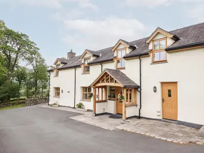 an exterior view of a house with a driveway at Ty Gwyn in Llangwm
