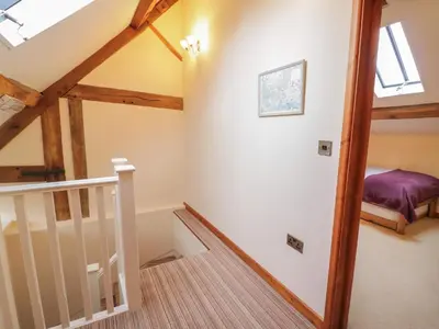 a staircase in a loft conversion with skylights at The Gallery in Craven Arms
