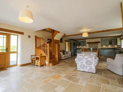 a living room with a couch and a table at The Hayloft in Knighton