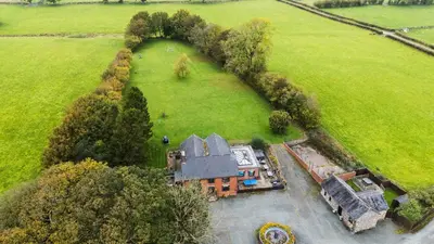 an aerial view of a large house in a field at Ty Newydd in Pont Dolanog