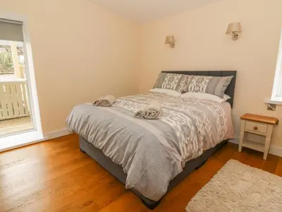 a bedroom with a bed with two towels on it at Y Felin - Moana in Borth
