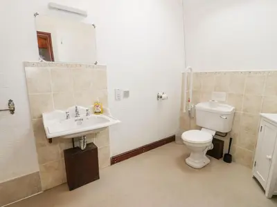 a bathroom with a sink and a toilet at The Dairy in Corwen
