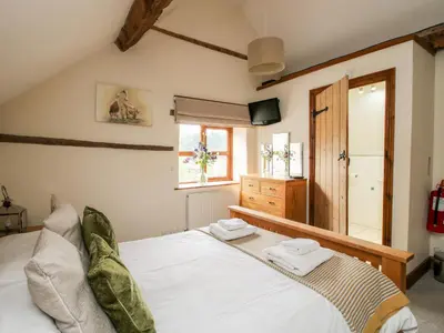 a bedroom with a bed with two towels on it at The Old Farmhouse in Craven Arms