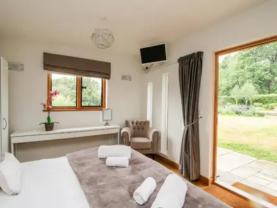 a bedroom with a large bed and a window at The Old Farmhouse in Craven Arms