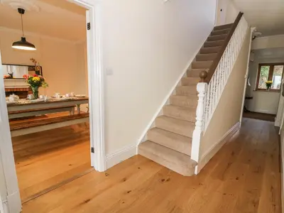 a staircase in a home with wooden floors at Oakwood House in Saint Harmon