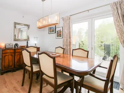 a dining room with a table and chairs and a window at Riverdale in Shrewsbury