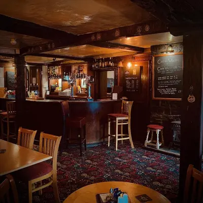 a bar in a pub with tables and chairs at Cain Valley Hotel in Llanfyllin