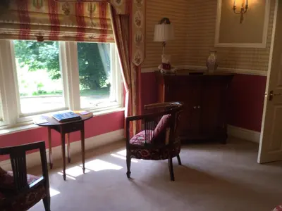 a room with a table and a chair and a window at Plas Y Dderwen Bed and Breakfast in Aberystwyth