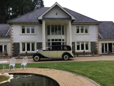 an old car parked in front of a house at Plas Y Dderwen Bed and Breakfast in Aberystwyth