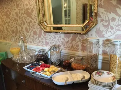 a table with a bowl of fruit and a mirror at Plas Y Dderwen Bed and Breakfast in Aberystwyth