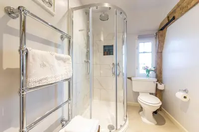 a bathroom with a shower and a toilet at Charlie's Cottage in Ludlow