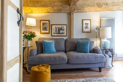a living room with a gray couch and blue pillows at Charlie's Cottage in Ludlow