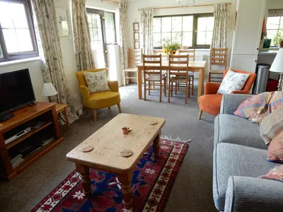 a living room with a couch and a coffee table at Kilsby Cottage in Llanwrtyd Wells