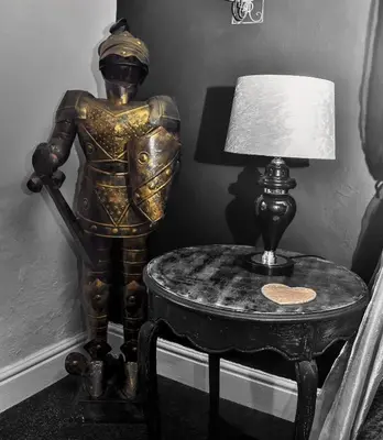 a statue of a man on a table next to a lamp at Peniarth arms in Llanegryn