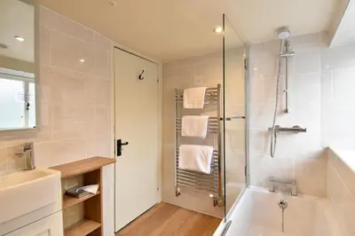 a bathroom with a shower and a tub and a sink at The Old Black Lion in Hay-on-Wye