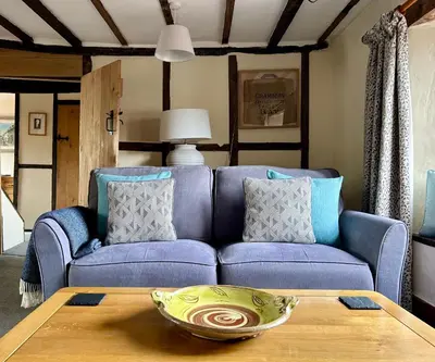 a living room with a blue couch and a table at Number 22, Castle Street in Hay-on-Wye