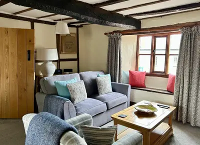 a living room with a couch and a table at Number 22, Castle Street in Hay-on-Wye