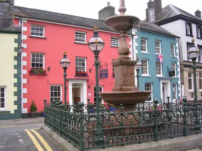 a fountain in front of a row of colorful houses at The Drovers Bed and Breakfast in Llandovery