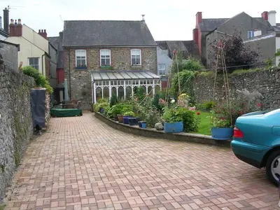 a brick driveway with a garden in front of a house at The Drovers Bed and Breakfast in Llandovery