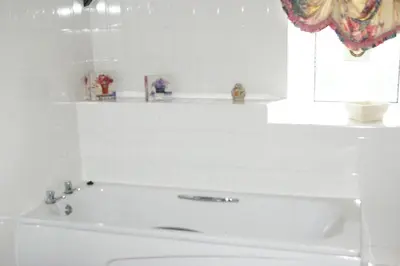 a white bath tub in a bathroom with a window at Plas Coch Hotel Ltd in Bala