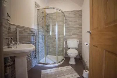 a bathroom with a shower and a toilet and a sink at Ludlow - Linnet House - Well Presented Townhouse With Parking - Perfect Location For Exploring On Foot, Sleeps Up To 8 Guests - Hosted by RENTMYHOUSE in Ludlow