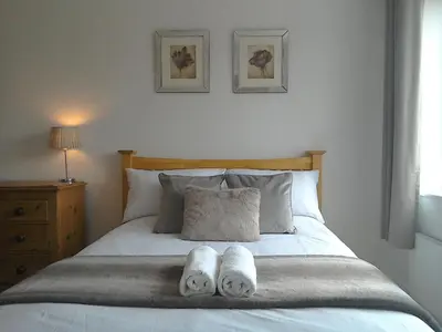 a bedroom with a bed with two towels on it at The annex at 44 Belvidere Road in Shrewsbury