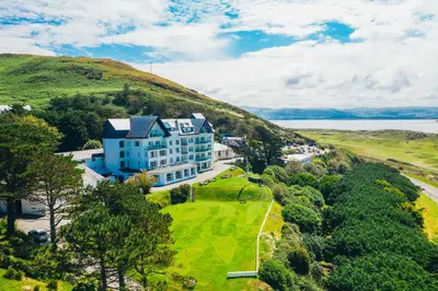 an aerial view of a house on a hill at Trefeddian Hotel in Aberdyfi
