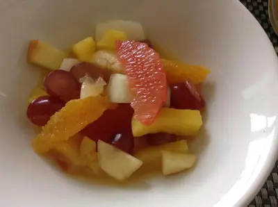 a white bowl filled with fruit on a table at Endeavour Guest House in Barmouth