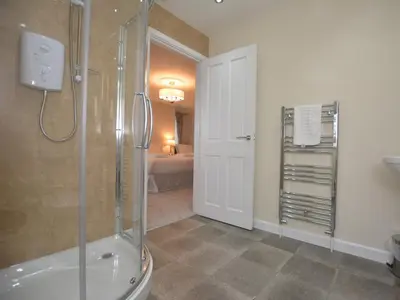 a bathroom with a shower and a walk in shower at Pengarreg Fawr in Llanilar