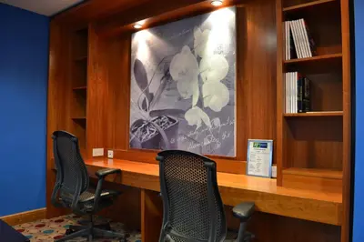 a meeting room with two chairs at a desk at Holiday Inn Express Shrewsbury by IHG in Shrewsbury