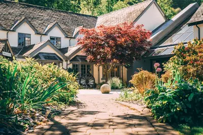 a house with a pathway leading to the front yard at Wild Pheasant Hotel & Spa in Llangollen