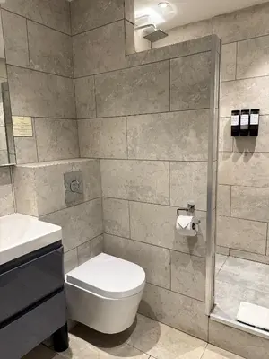 a bathroom with a toilet and a shower at Wild Pheasant Hotel & Spa in Llangollen